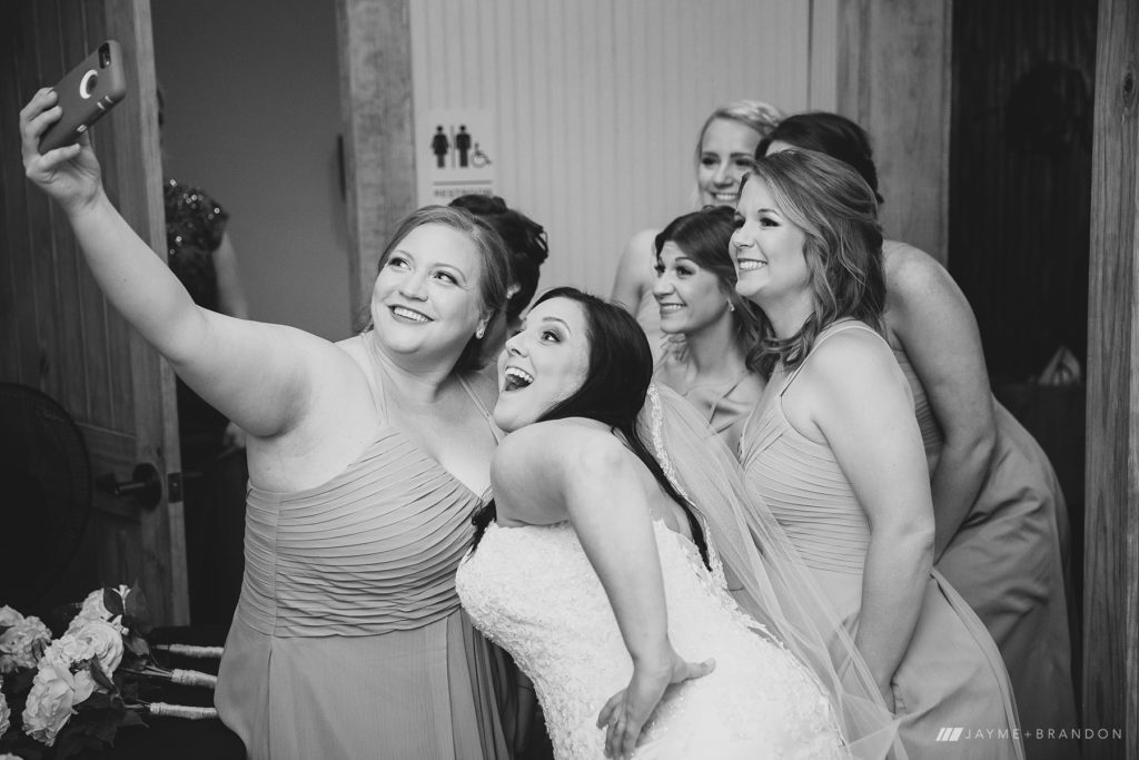 Bride and Bridesmaids pose for candid selfie together at Warehouse 535 Bridal Suite
